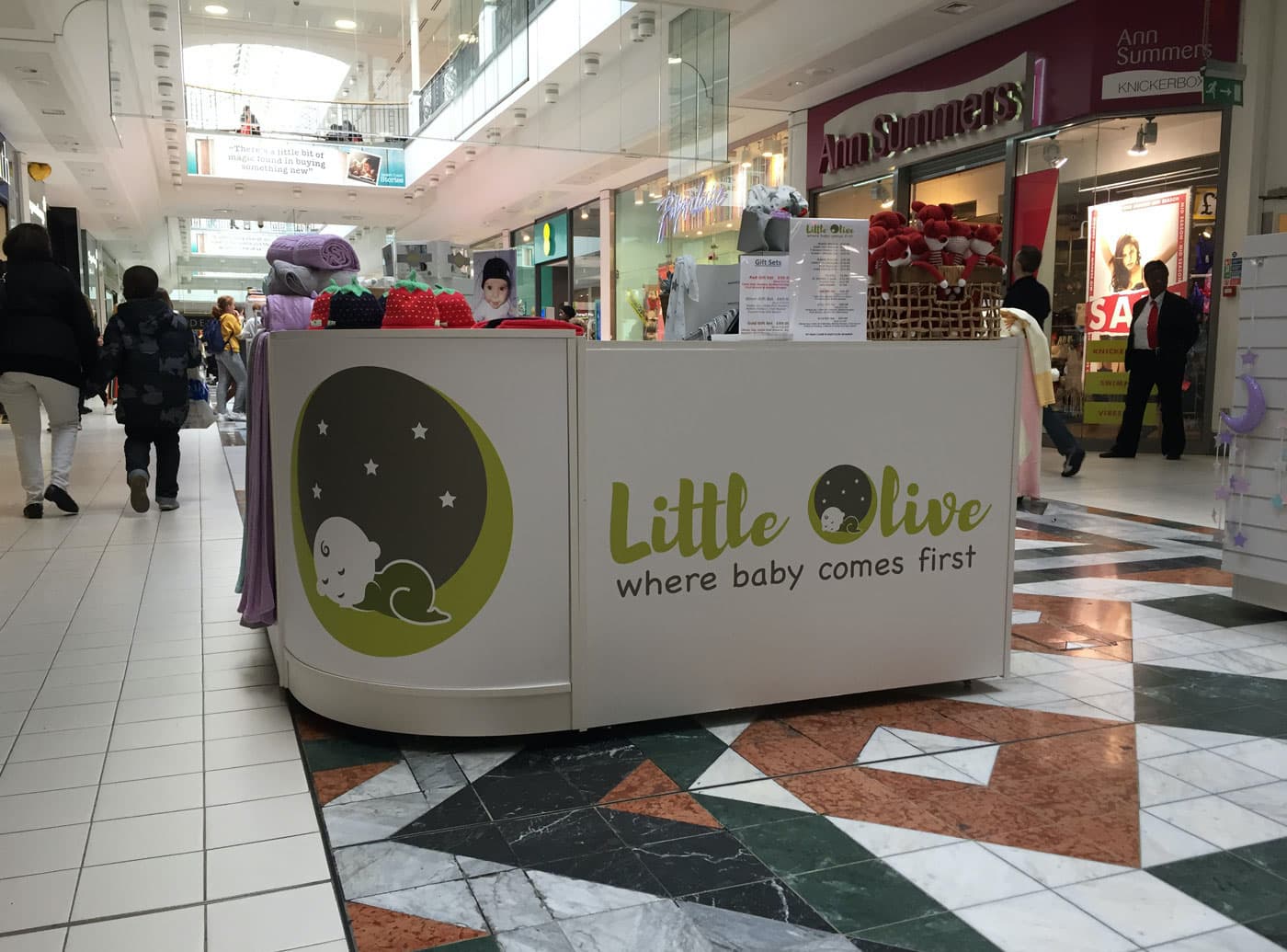 a shopping centre with a stall by Little Olive, logo and signage designed by Bell Pepper Design