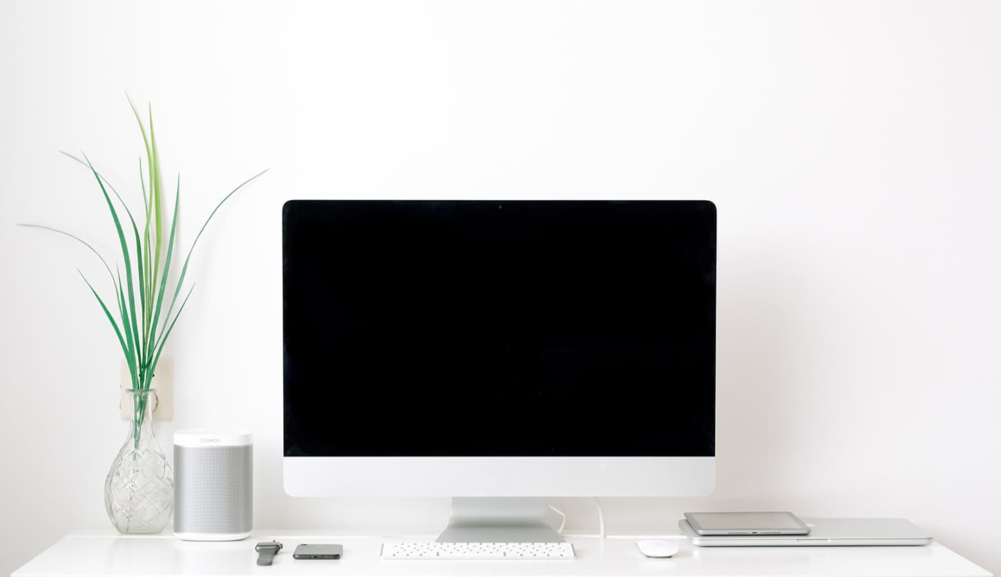 a computer setup on a desk. Photo by Jessy Smith on unsplash.com